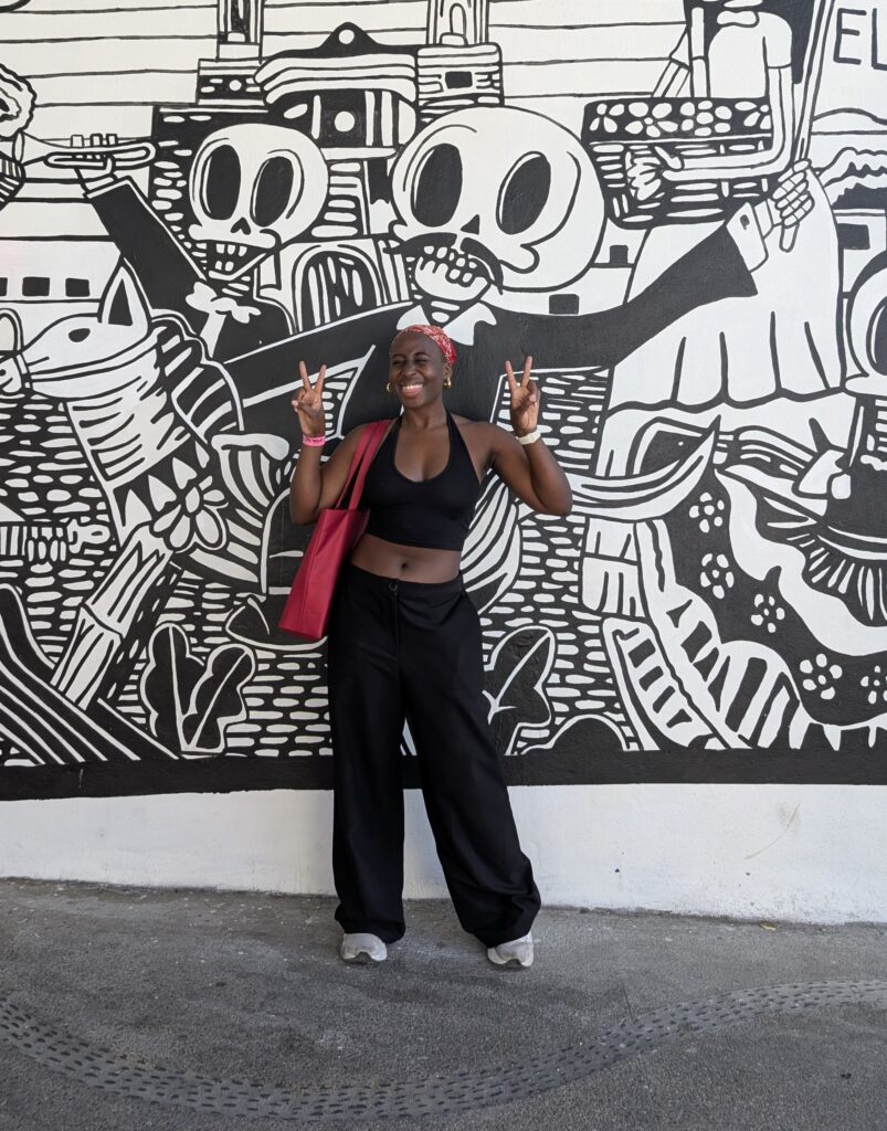 A Black Woman wearing a halter neck top and loose low rise trousers in Puerto Vallarta
